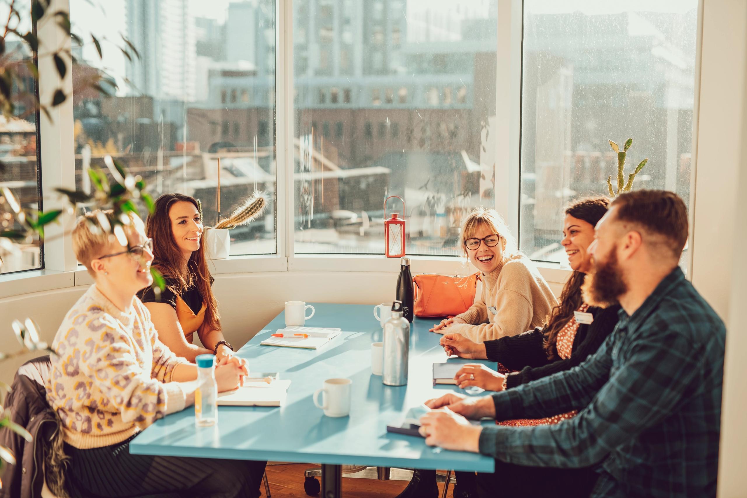 A group of people smiling around a table