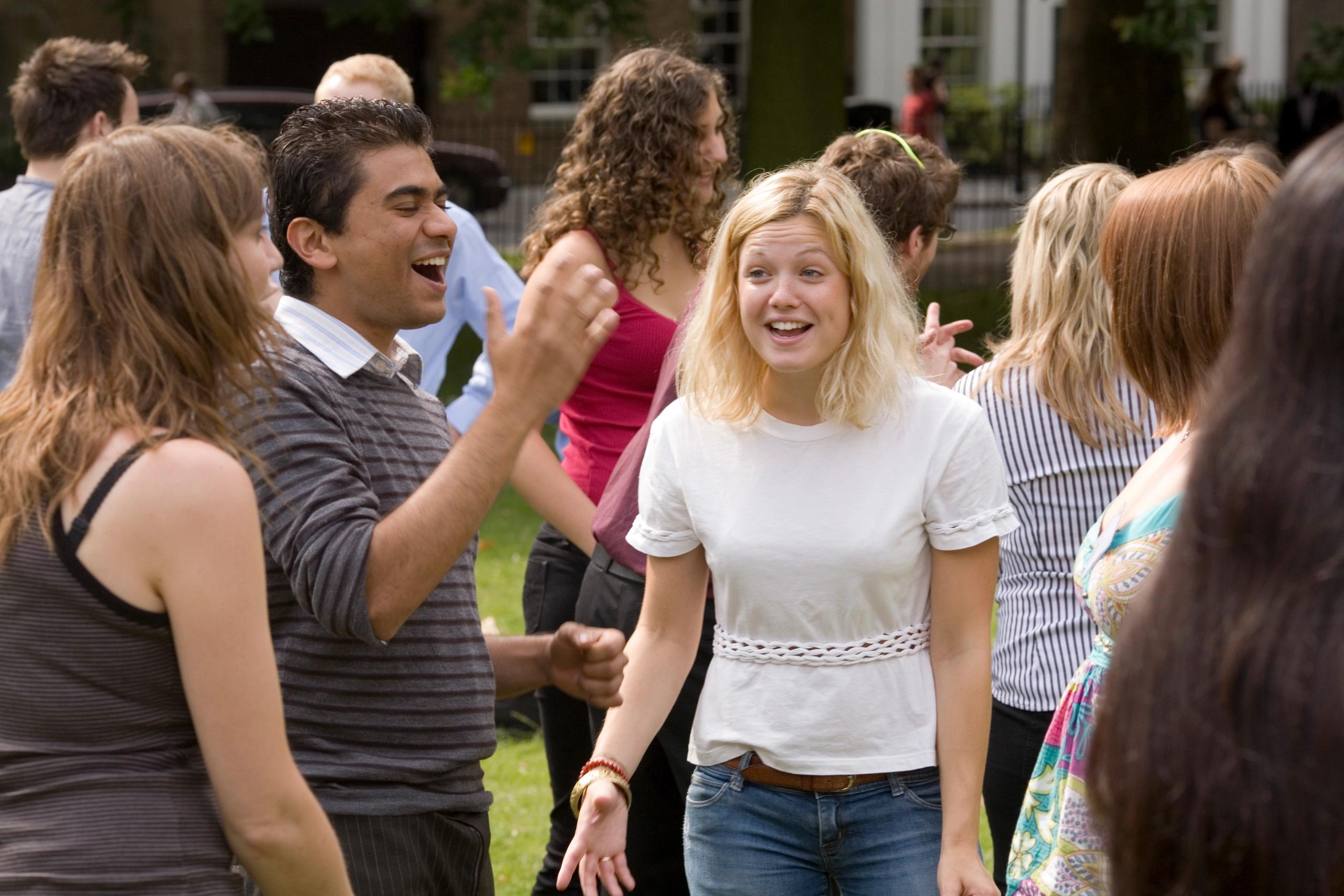 A group of young people laughing outdoors