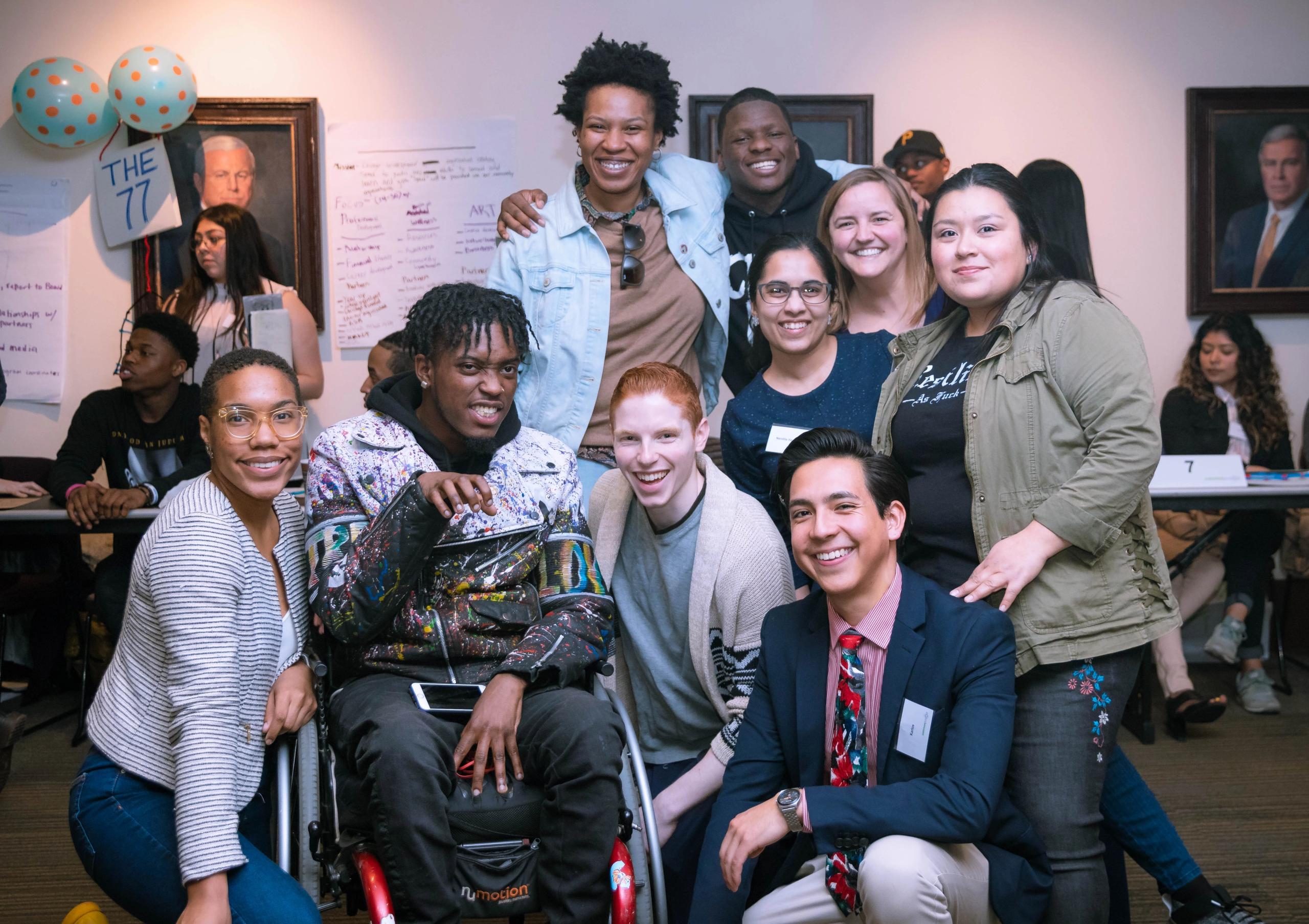 A group of young people posing for a photo indoors