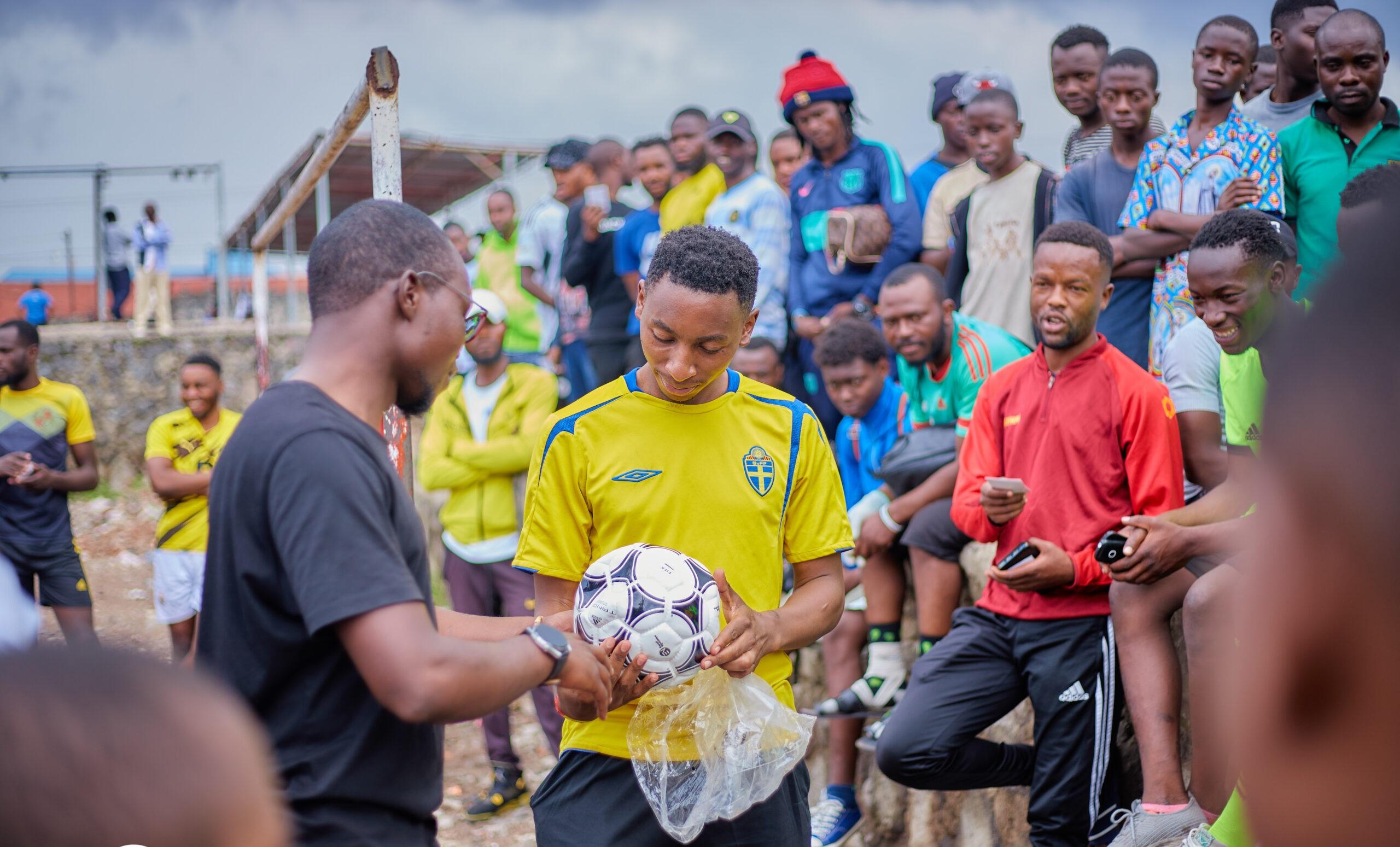 Espoir gifting a football