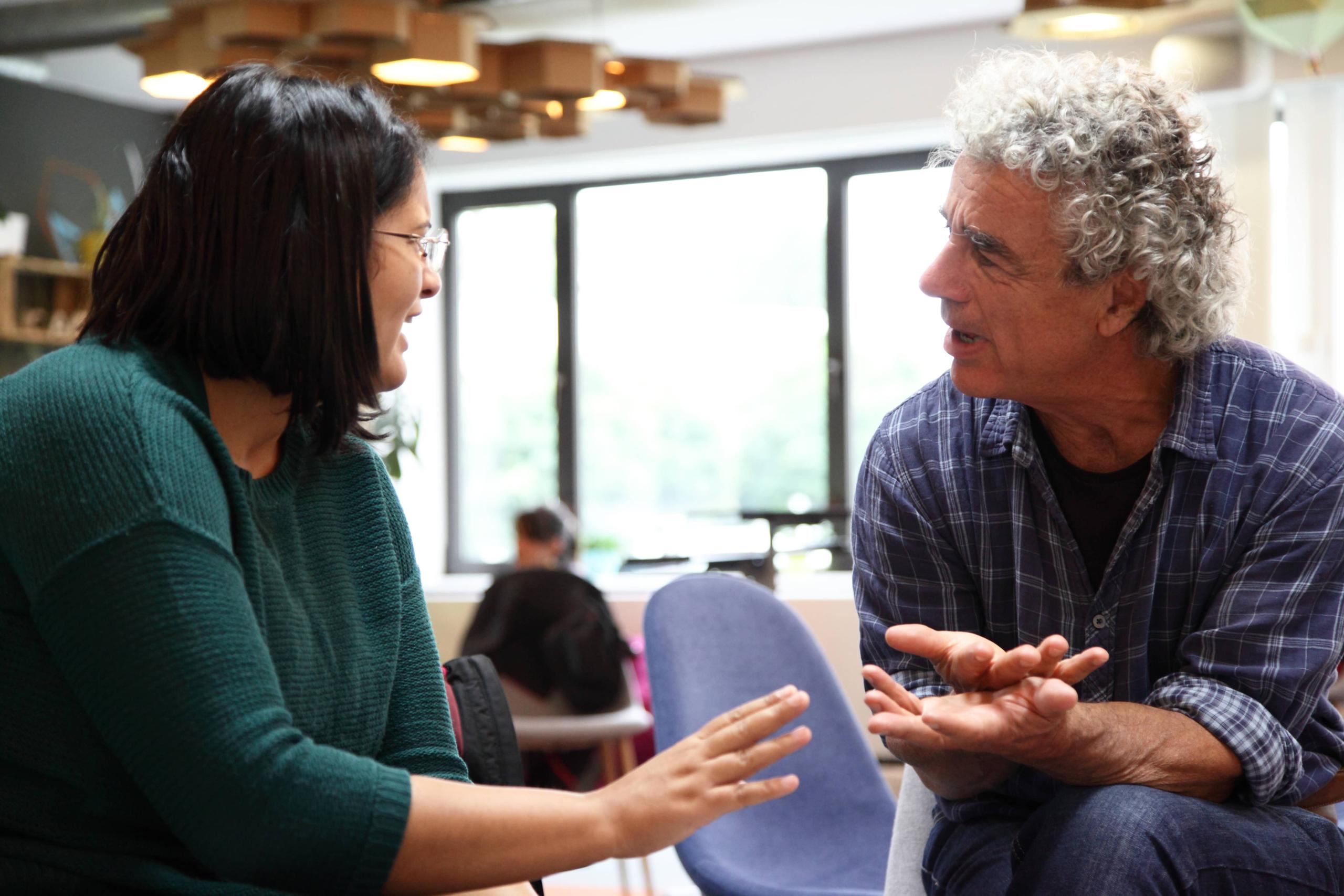 Two people seated in the discussion